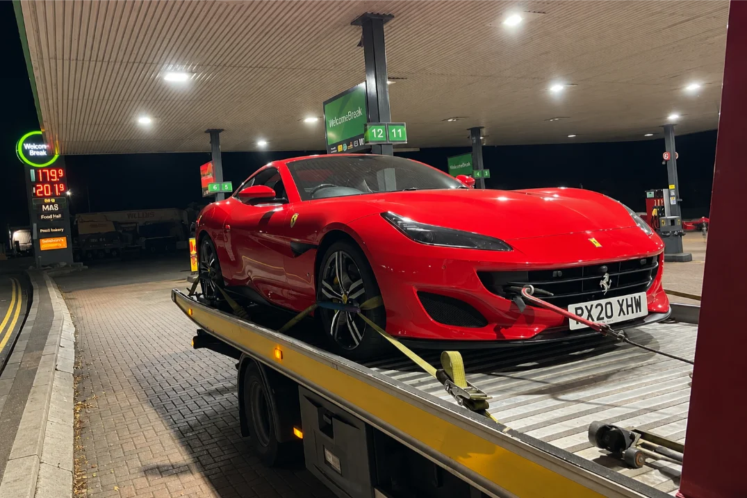 Ferrari luxury car on a Flatbed at Night
