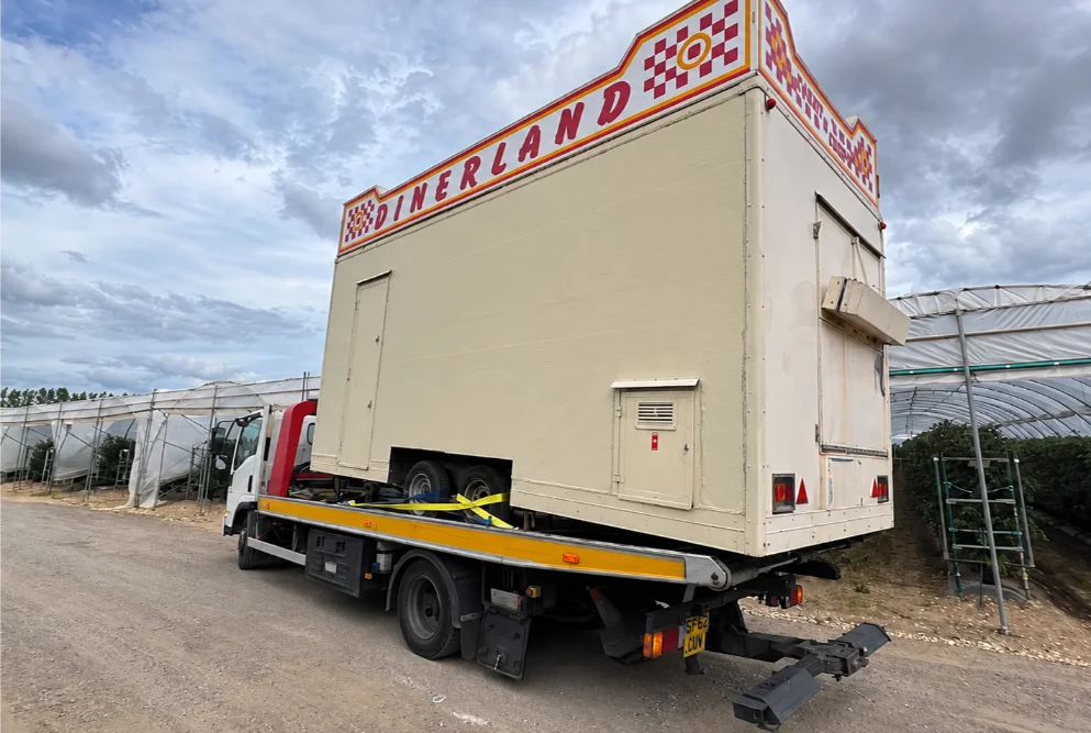 Retro Diner Truck Among Greenhouses Commercial Vehicle Recovery
